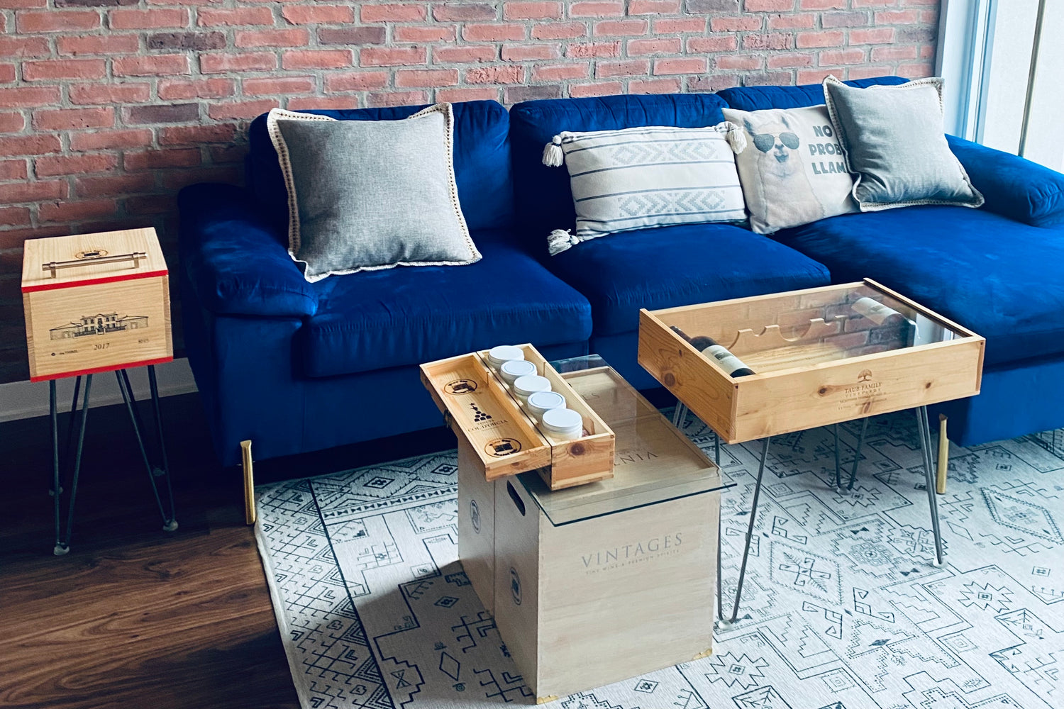 Upcycled wine crate end table, storage boxes, and coffee table in modern living room decor.